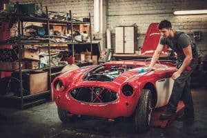 Getting Started with Classics Part 2 - Facilities, Tools and Skills | Image shows young mechanic with Healey car