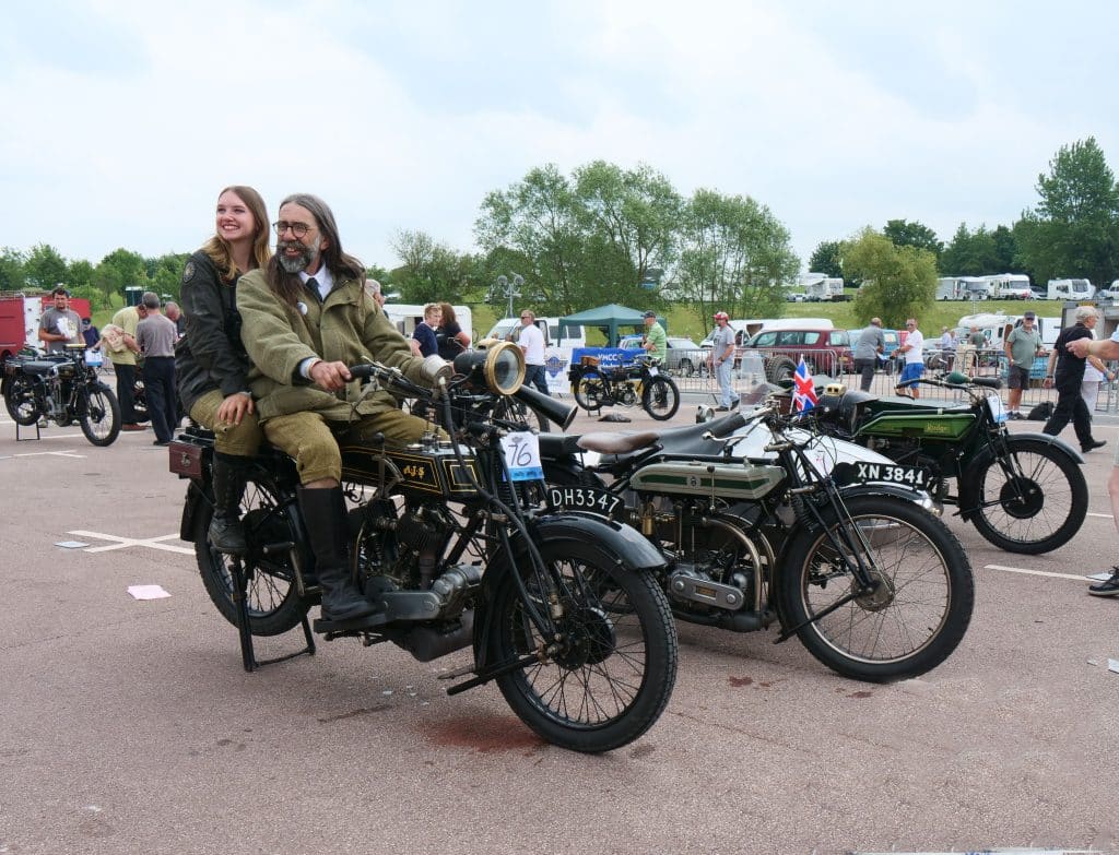 Two riders sit on a vintage motorcycle at the Banbury Run